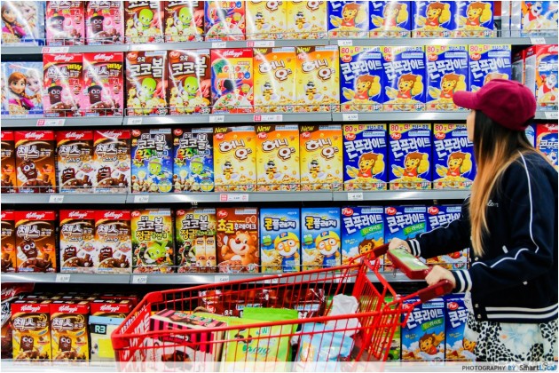 The Smart Local - Kimberly shopping at Lotte Mart viewing a wall of Korean cereal