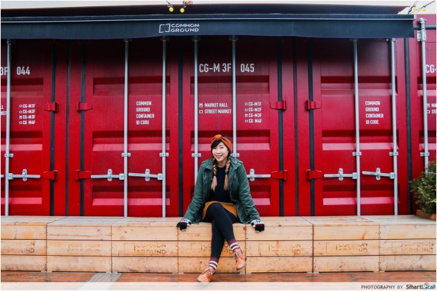 The Smart Local - Kimberly posing in front of a red common Ground container