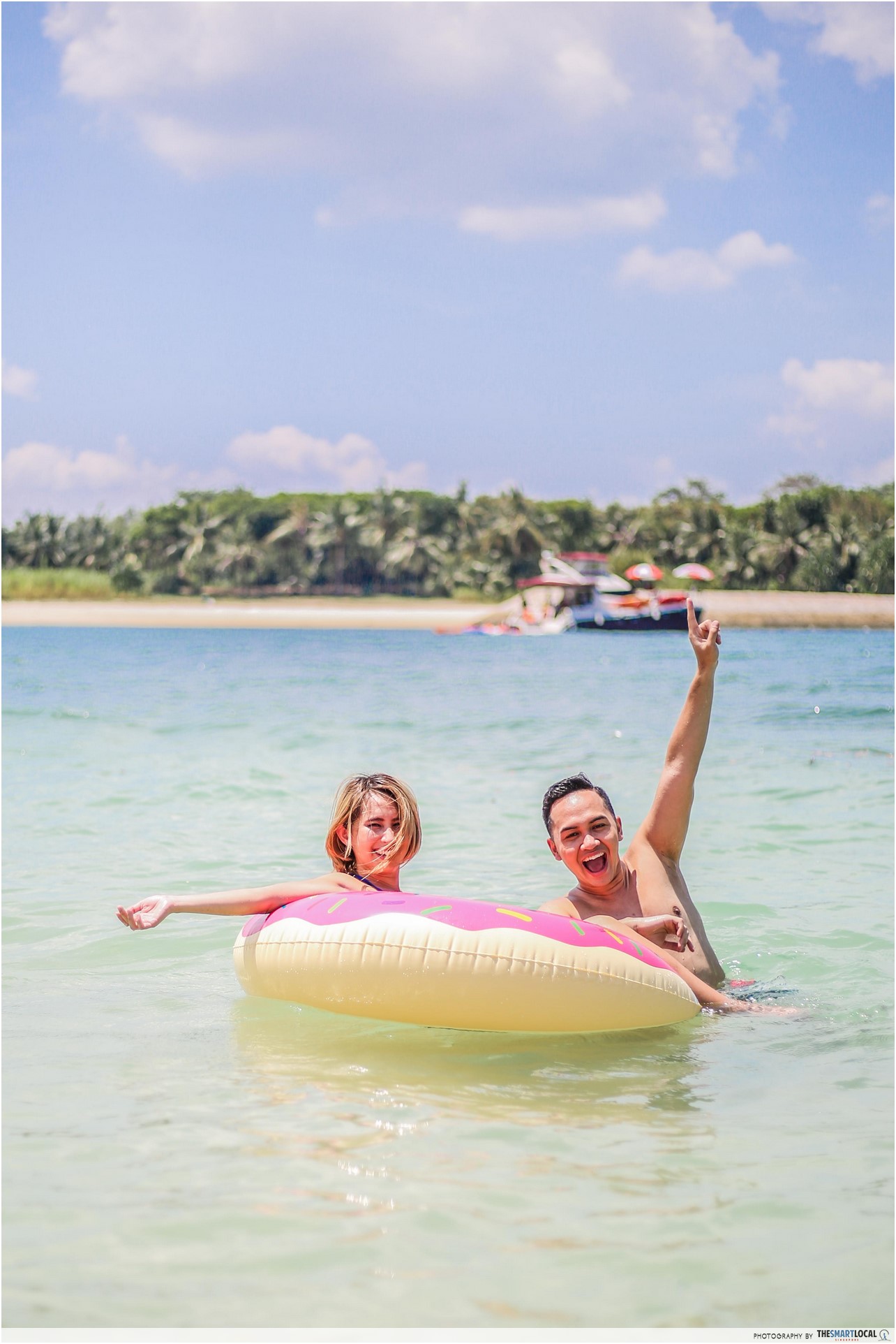 fauzi and beatrice having fun with their float on lazarus island beach