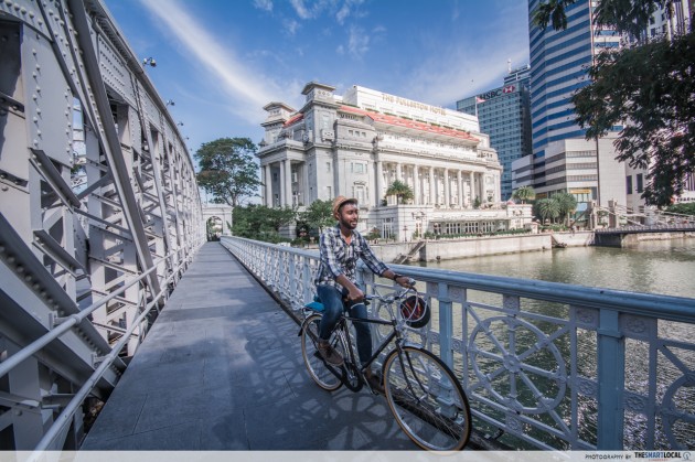 cycling with the fullerton hotel in the background