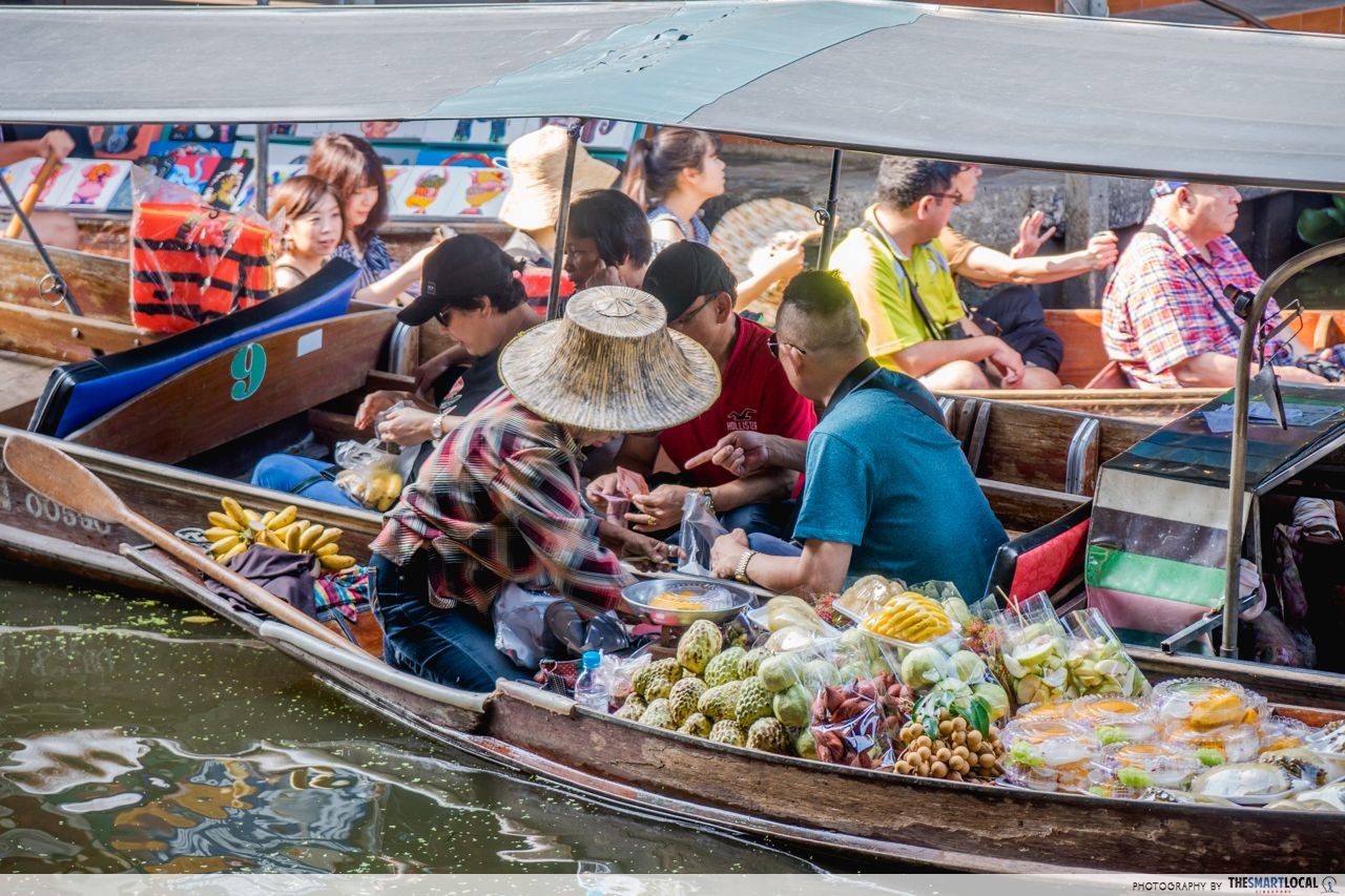 Tourists buying food from their rowboats