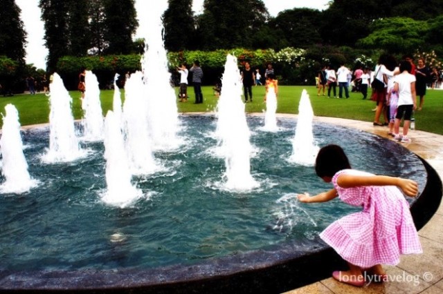 Girl playing near Istana fountain