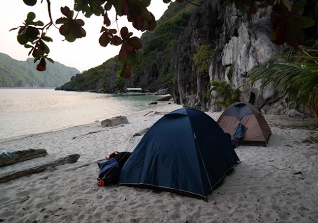 camp overnight on the beach after a day of climbing