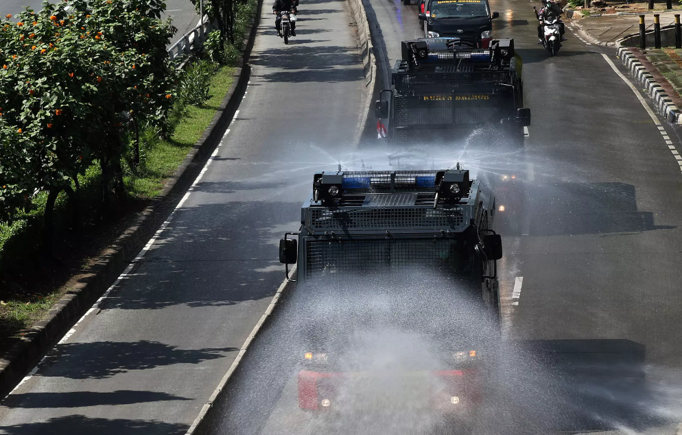Water cannons spray disinfectant in Jakarta