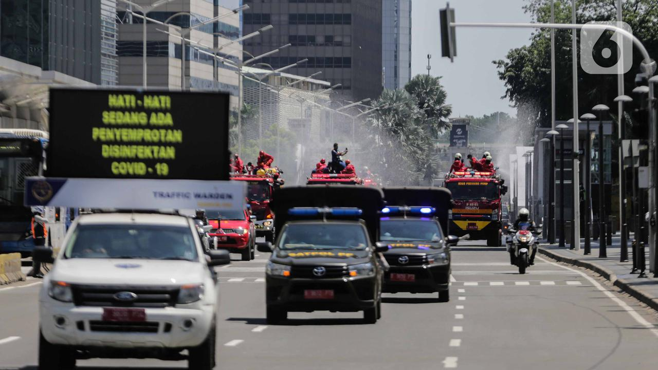 Firefighters spray disinfectant in Jakarta