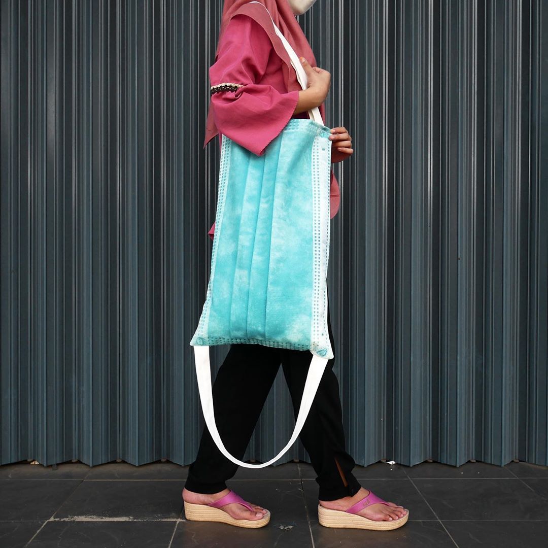 Woman wearing a surgical face mask tote bag