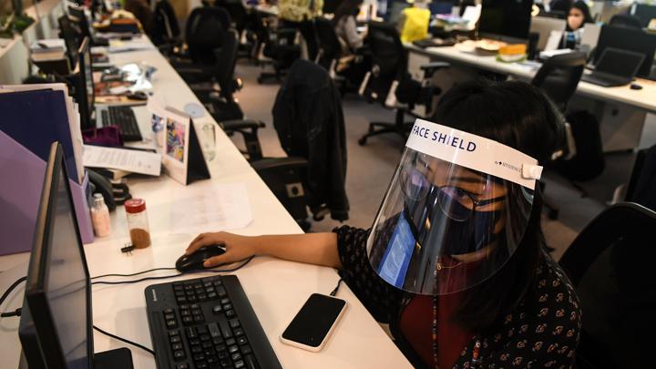 Office clusters in Indonesian cities - Woman wearing a face shield