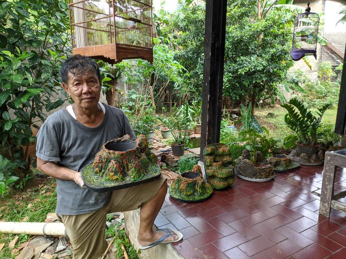 Retiree makes handmade pots - Retiree showing off his creations