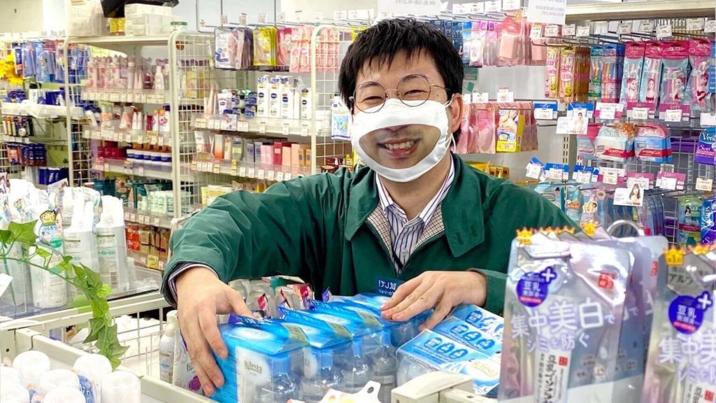Smile masks in Japan - male employee wearing smile mask 