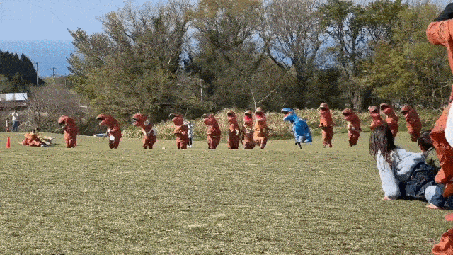 Dinosaur race in Japan - gif of runners in t-rex suits sprinting 