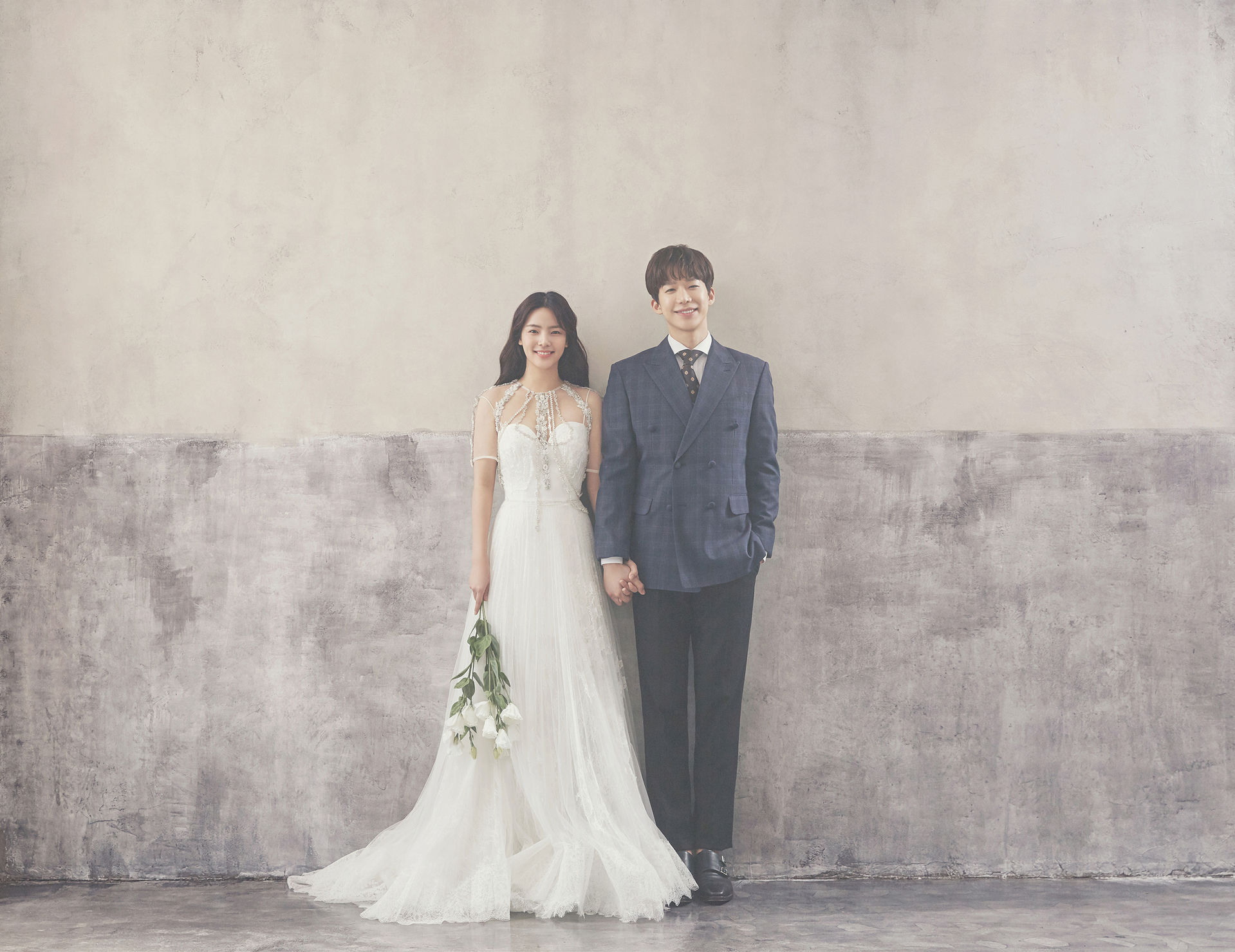 korean wedding photoshoot couple shot against a wall