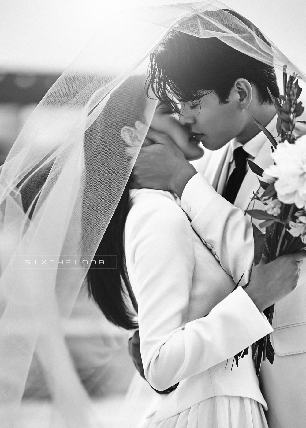 korean wedding photoshoot groom and bride sharing a kiss