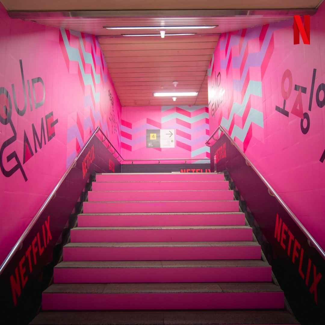 Squid Game Pop-Up Playground - itaewon station stairs covered in hot pink