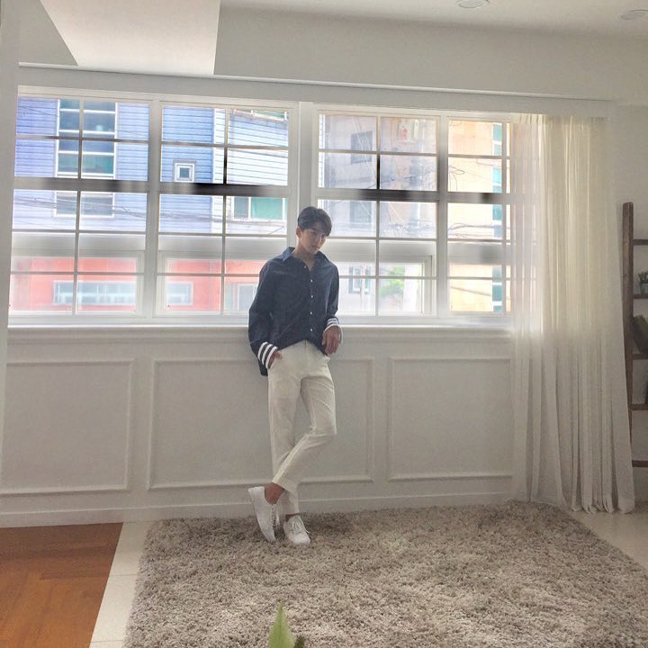 kim min kyu facts - instagram post posing in front of window