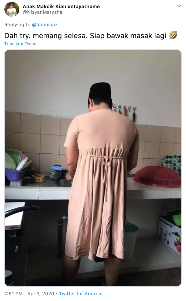 Man wears dress while cooking