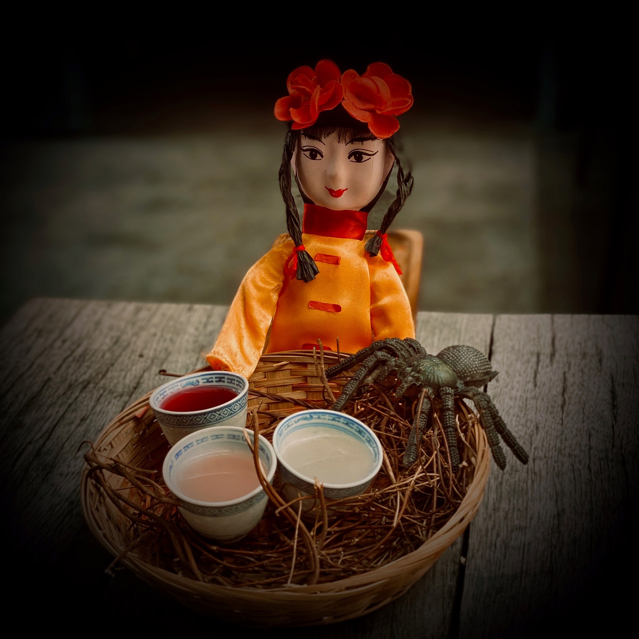 cocktail with chinese doll and spider as props