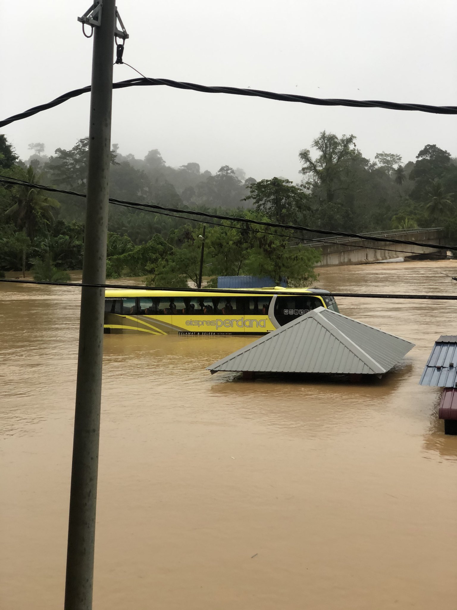 bus submerged in flood waters