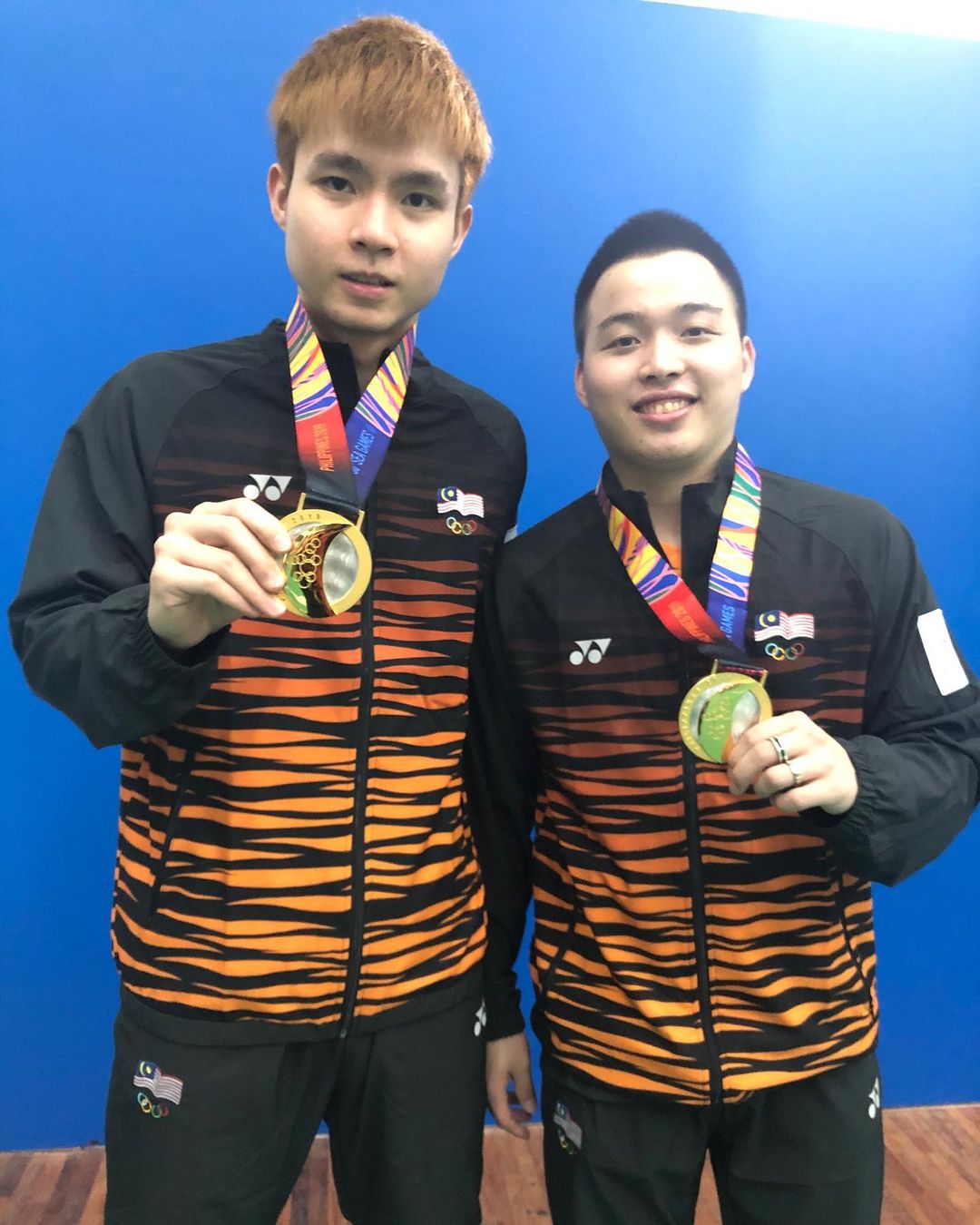 Aaron Chia and Soh Wooi Yik after winning a match