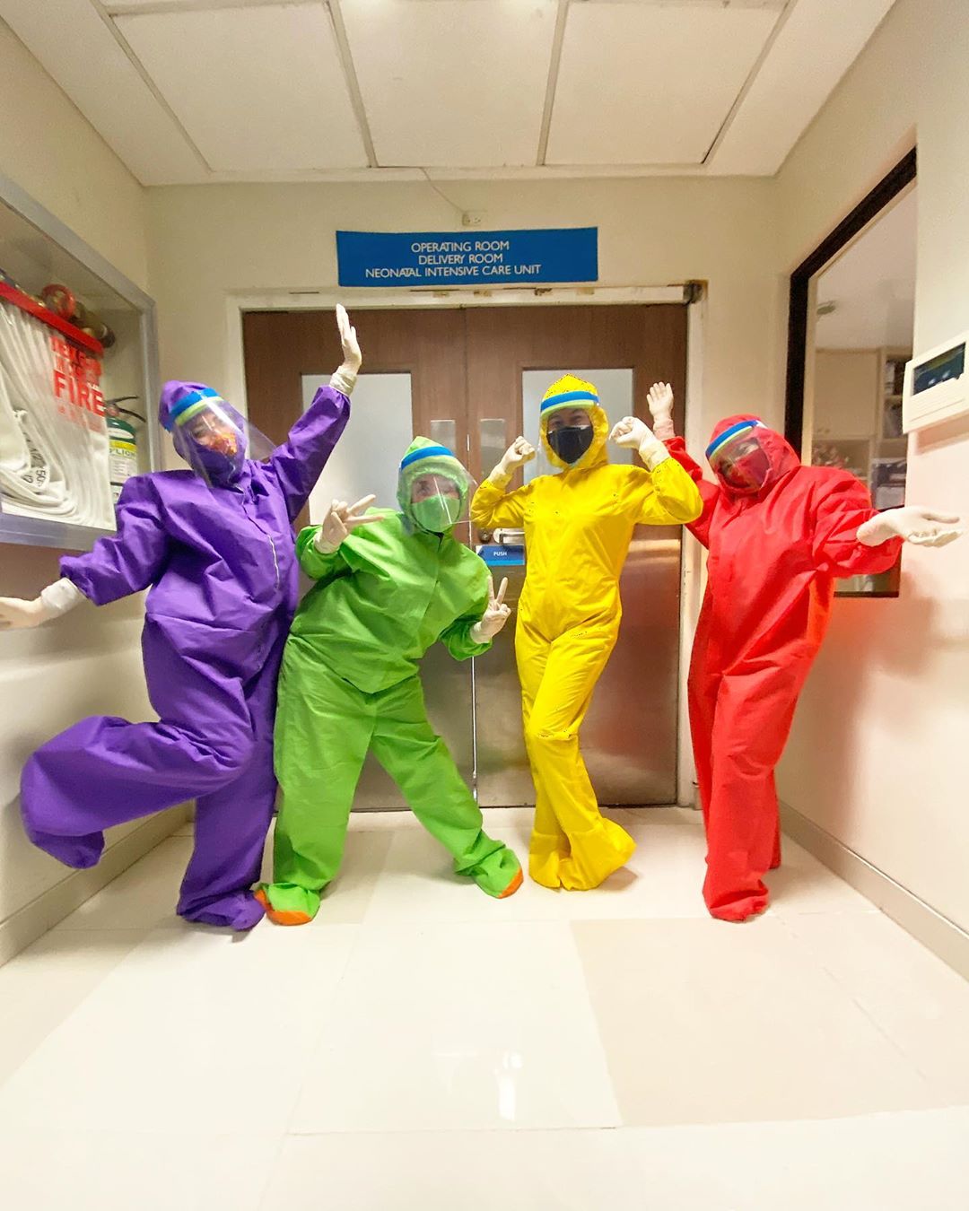 health workers in rainbow hazmat suits