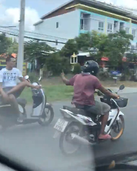 Man Sitting Cross-Legged on Moving Motorcycle Thailand