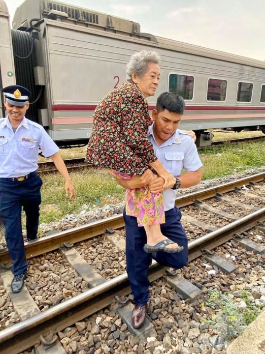 Grandma Has Difficulty Getting Off Train, Conductor Comes To The Rescue And Carries Her Across Tracks