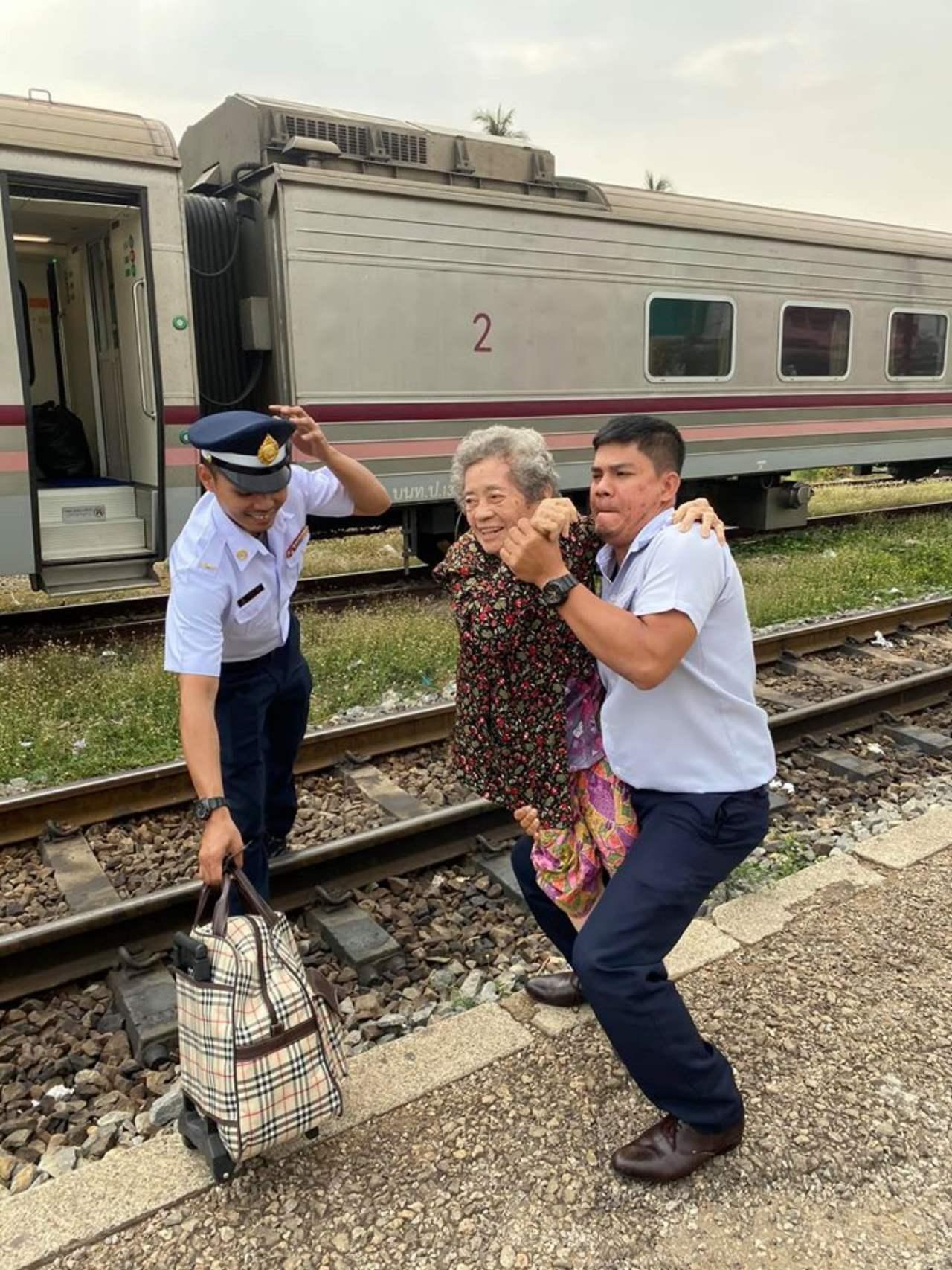 Grandma Has Difficulty Getting Off Train, Conductor Comes To The Rescue And Carries Her Across Tracks