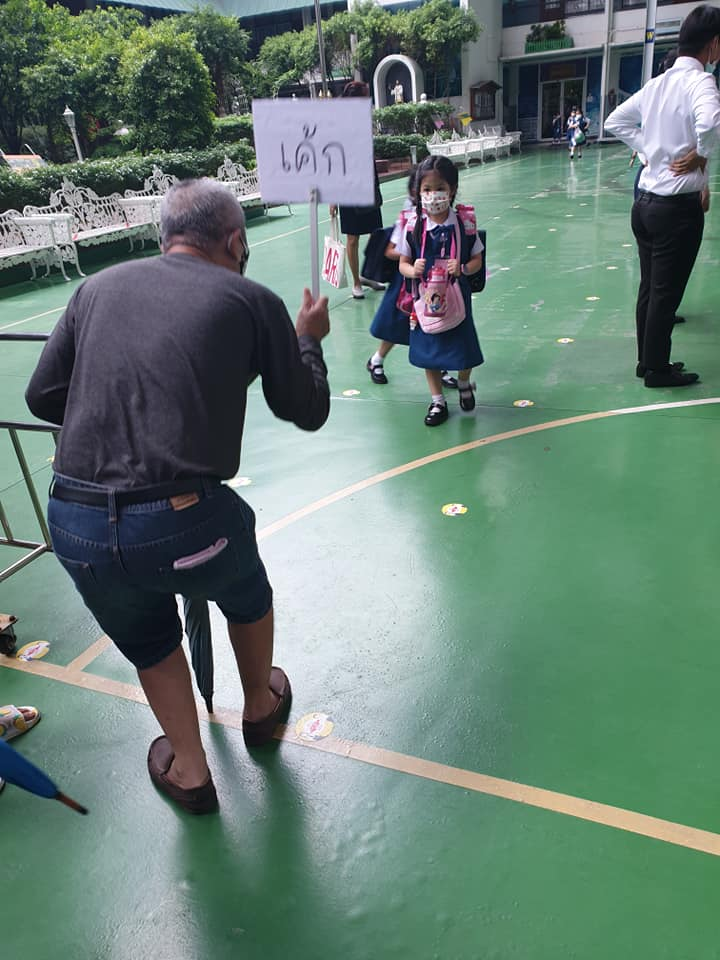 Thai grandpa makes a sign to pick up the right grandkid