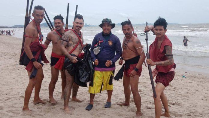 Thai volunteers clean the beach