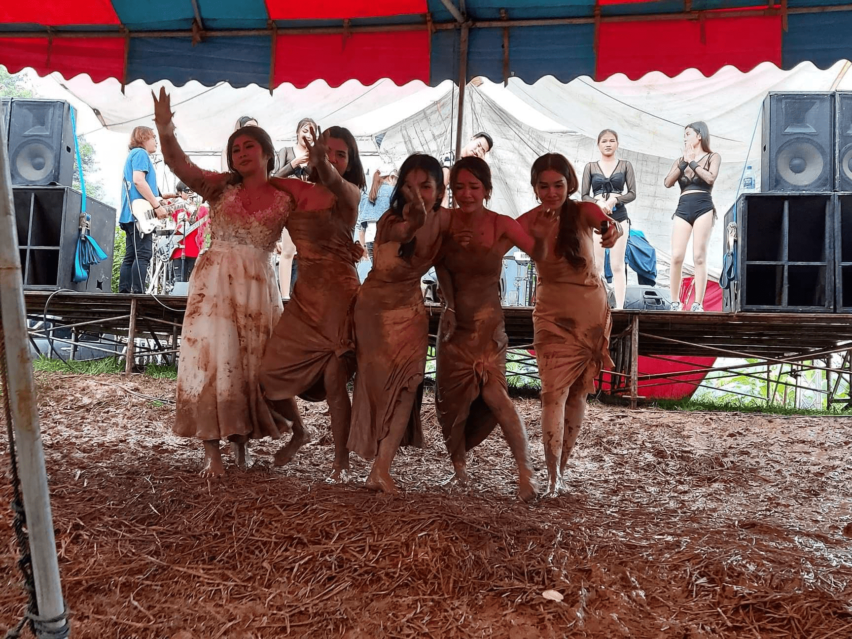 Bridesmaids dance in mud