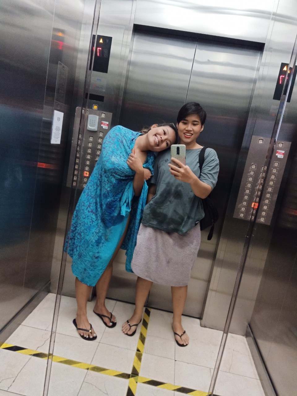 Two friends in an elevator