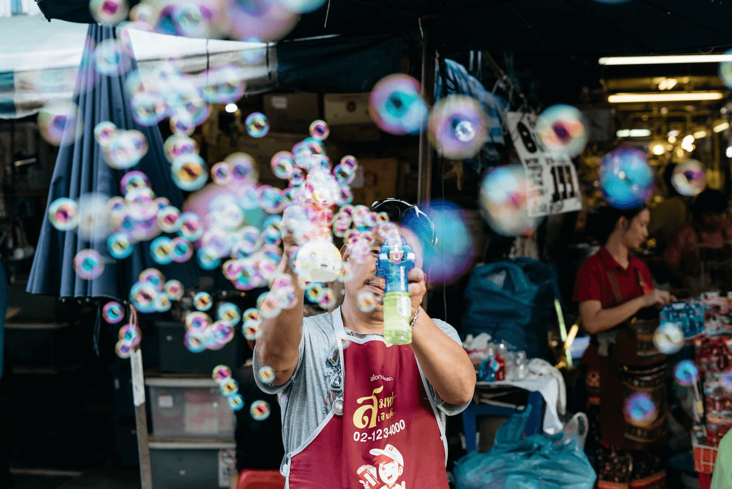 man spraying bubbles