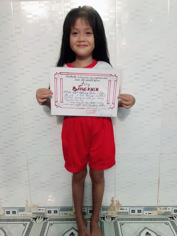 girl with certificate from grandpa