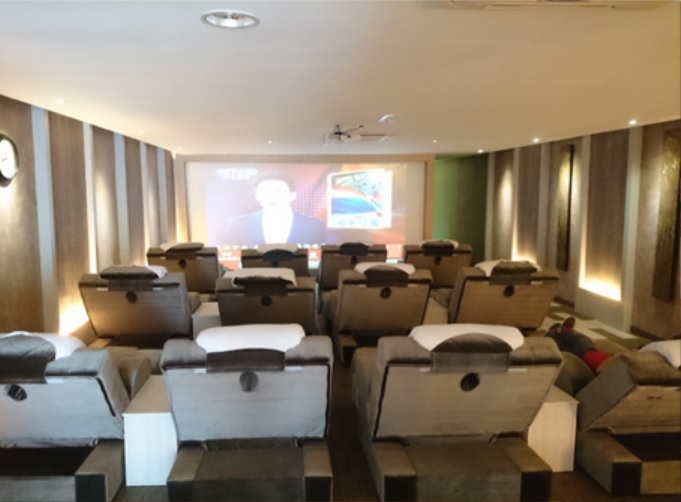 In-house theatre with massage chairs at Reborn Wellness