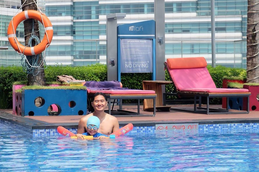 Kid with father at Aloft KL rooftop pool
