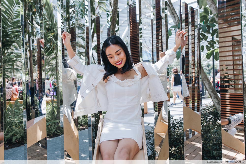 Girl posing at mirrored panes at Jewel Changi
