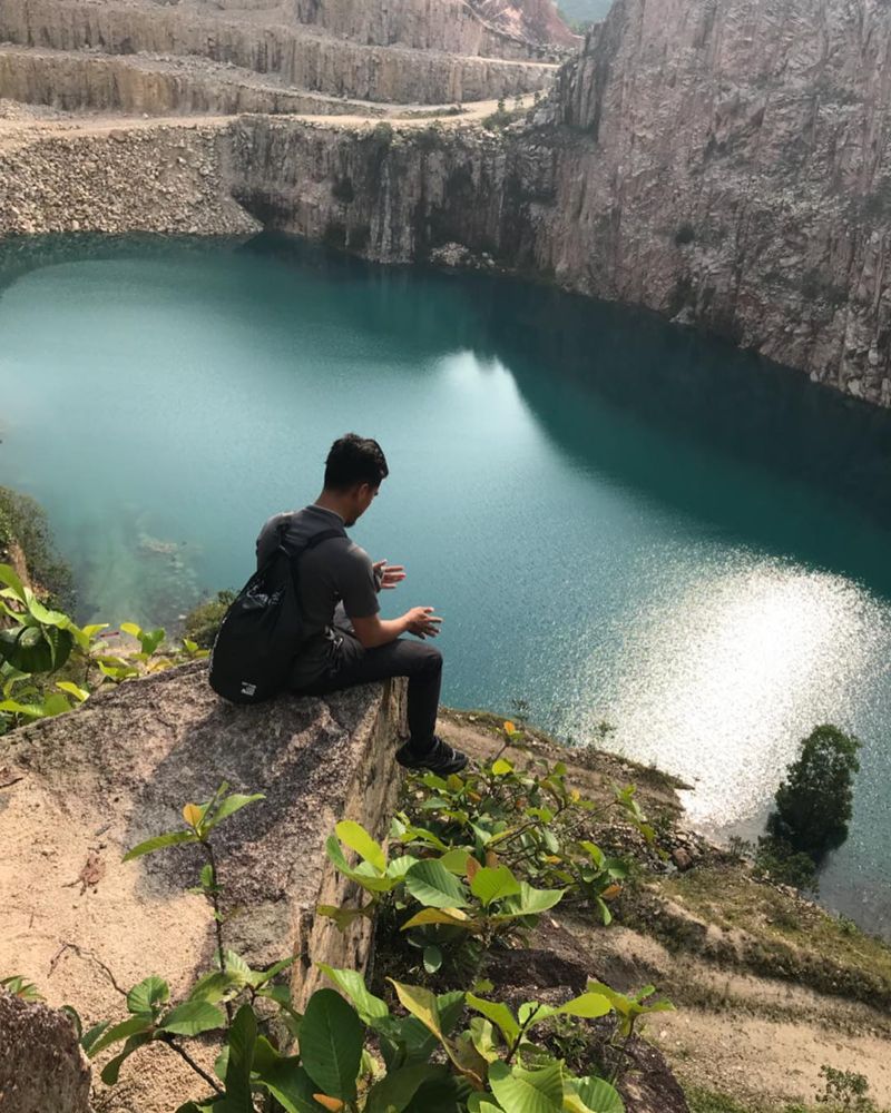 Guy sitting by quarry at Mount Pulai