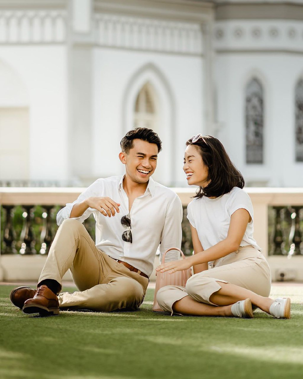 couple having a picnic together on a lawn CHIJMES