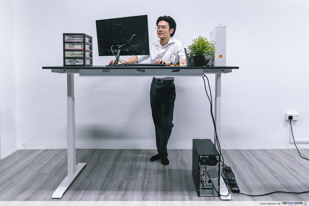 man using an omnidesk standing desk