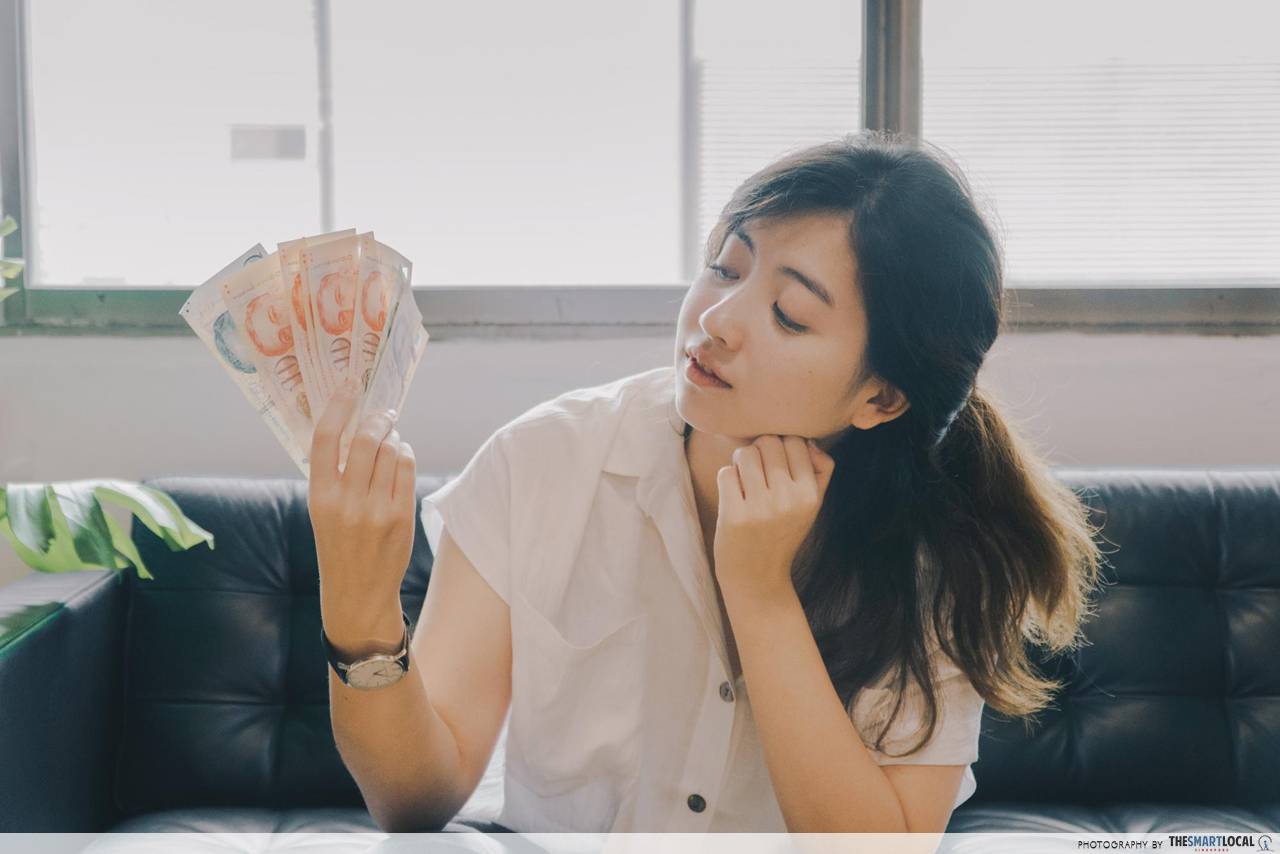 woman looking at singapore dollars