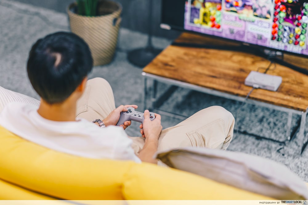person sitting on a sofa gaming