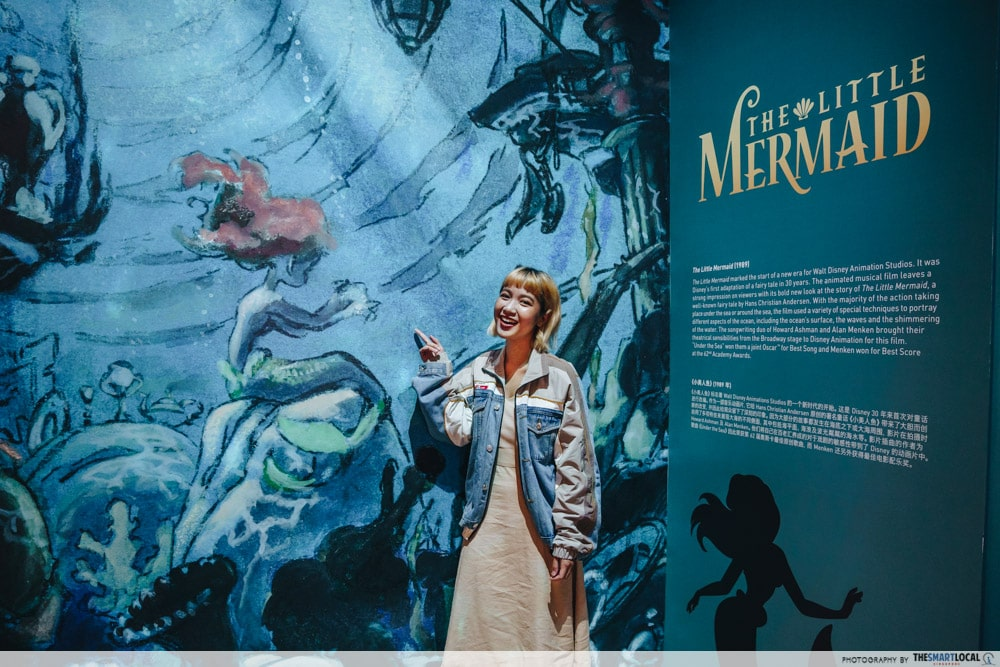 Image of woman standing in front of the Little Mermaid exhibit at ArtScience Museum