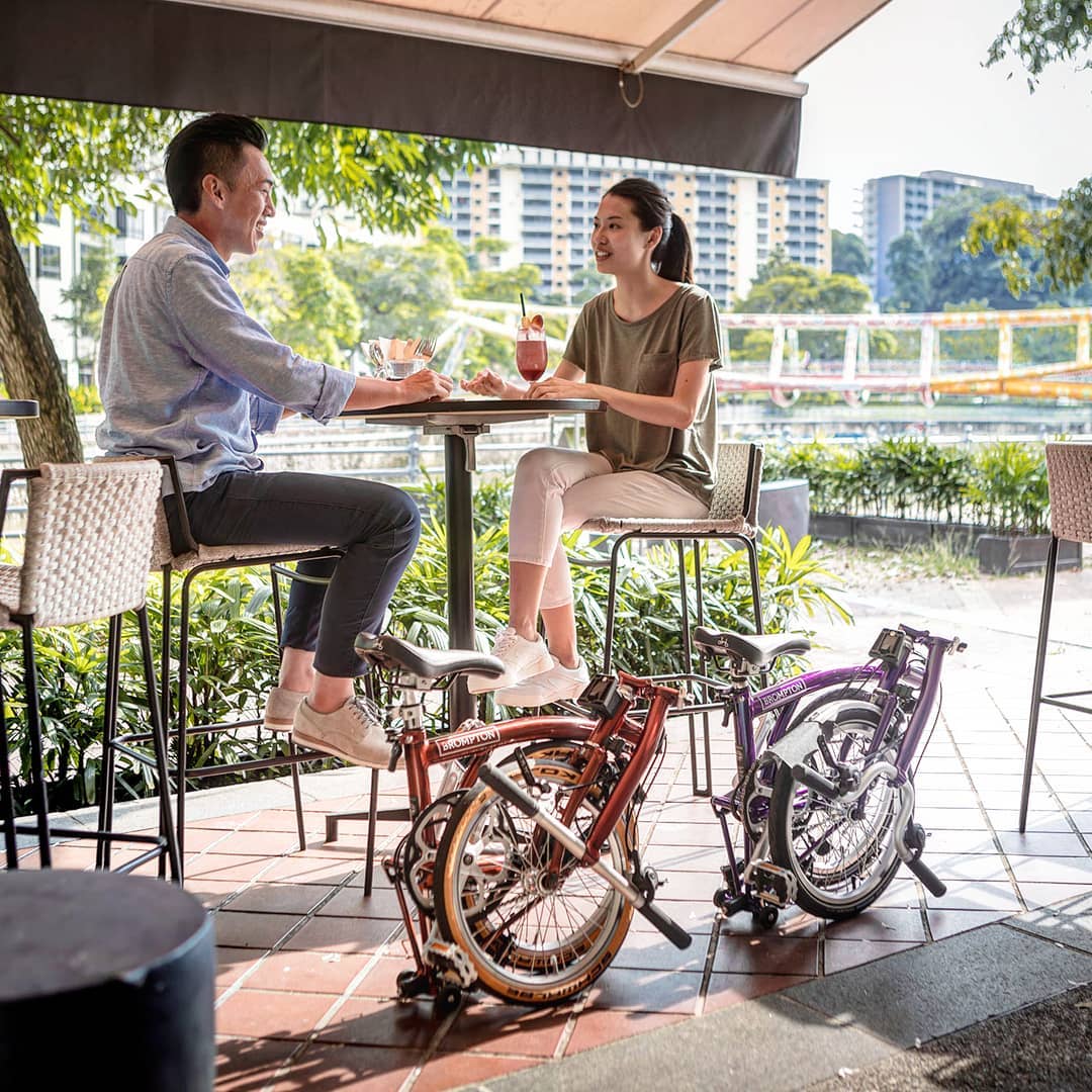brompton bicycles can fold small enough to fit under tables