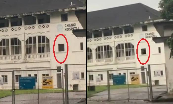 still from video footage of old changi hospital showing moving black figure