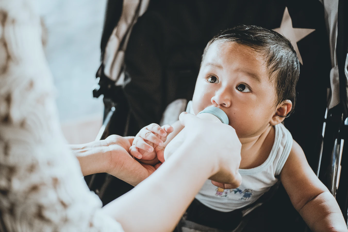 Adoption in Singapore - Parent feeding baby