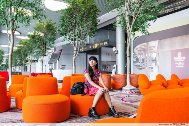 Girl sitting at Changi Airport terminal