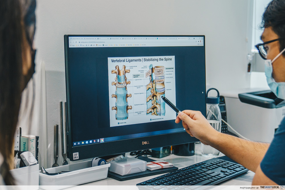 Doctor showing spine diagram to patient