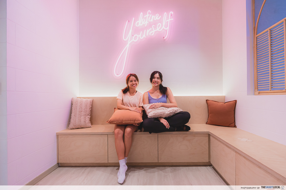 off duty pilates orchard girls posing at neon sign