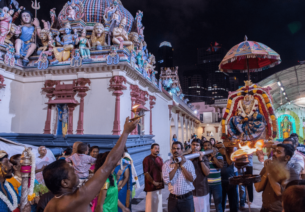 a religious procession at sri mariamman temple with devotees