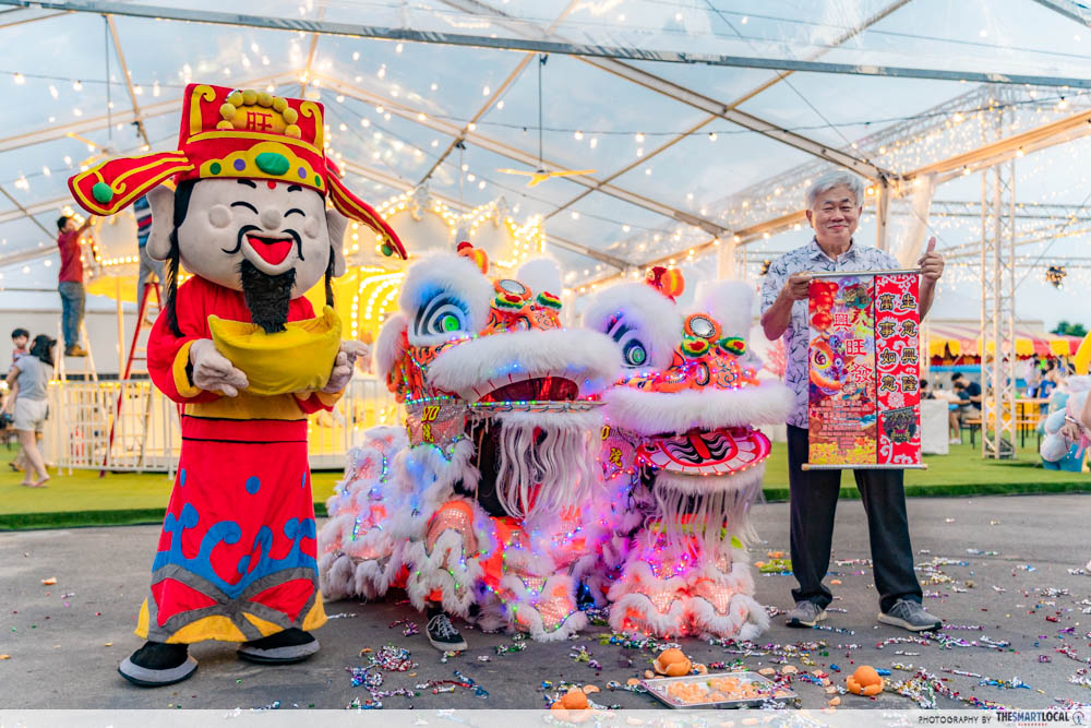 lion dance dancers and god of fortune mascot at bay spring carnival 