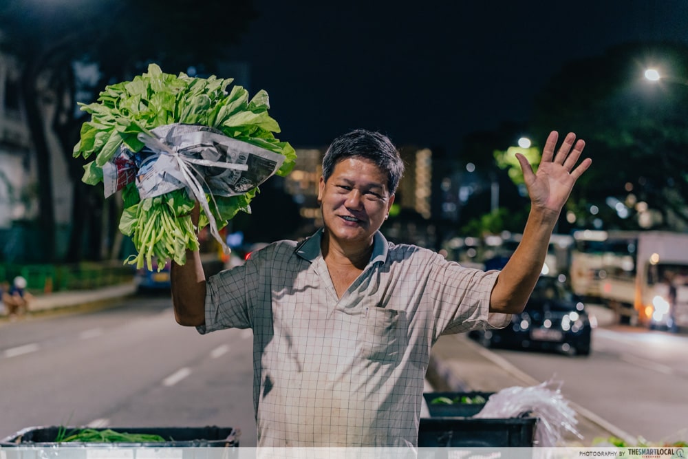 Toa Payoh Vegetable Night Market - Street Vendor Showing Off Vegetables